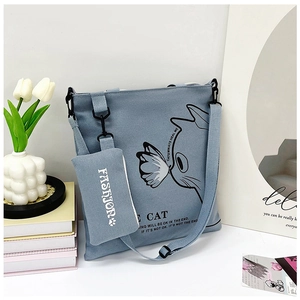 Light blue canvas tote bag set with cat illustration and adjustable shoulder strap