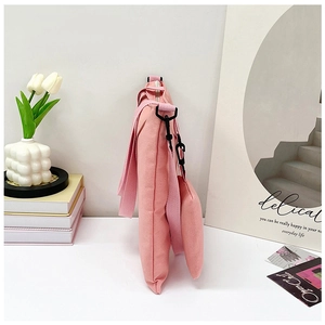 Side view of pink canvas tote bag set with metal buckles and decorative shoulder straps
