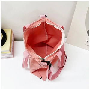 Deep interior view of a pink canvas tote bag with zipper closure and printed pattern
