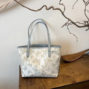 Elegant jacquard tote bag with butterfly embroidery and stylish faux leather handles