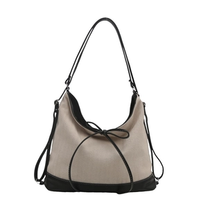 Large canvas tote bag with black leather contrast trim and a stylish bow knot accent