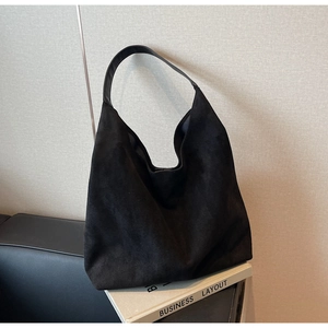 Detailed macro shot of the black matte suede texture on the large shoulder tote bag
