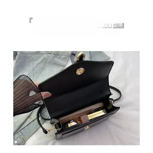 Interior view of black leather crossbody bag showing capacity for phone and cosmetics