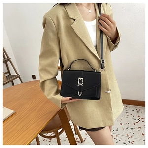 Classic black crossbody bag with elegant gold clasp and V-shaped flap design