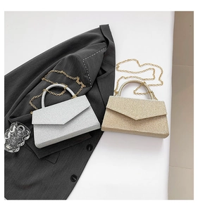 Close-up of sparkling sequin envelope bags in gold and silver with elegant chain straps