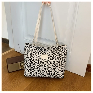 Detail view of the leopard print pattern and chic leather patch on the stylish tote bag