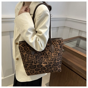 Detailed close-up of brown leopard print tote bag with dark brown leather straps