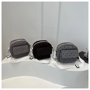 Three minimalist canvas crossbody bags in gray and black with polka dots and heart patterns