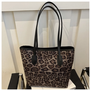Macro view of leopard print tote bag with black slim handles for daily commute