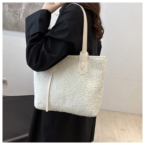 Detail of white plush faux shearling tote bag with off-white leather shoulder straps