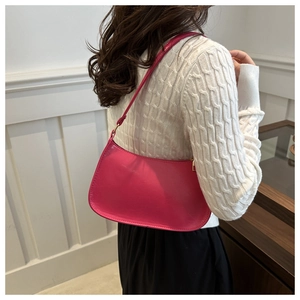 Glossy magenta faux leather underarm bag in minimalist crescent shape for women