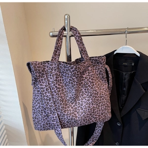 Large leopard print canvas tote bag in purple with dual handles and shoulder strap