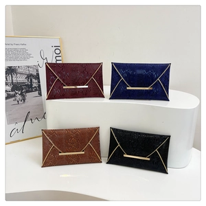 Envelope evening clutch bag with snake pattern and gold trim in four elegant colors