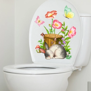 Detail of cute grey rabbit and pink flower PVC stickers on a white toilet lid