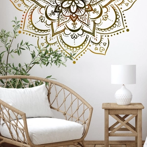 Detail of a gold mandala wall decal applied to a white wall in a modern living room