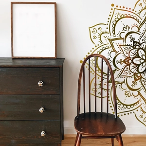 Detail of large mandala wall sticker with gold gradient geometric pattern in living room