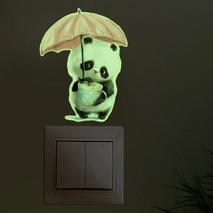 Autocollant panda lumineux avec parapluie brillant sur un interrupteur dans le noir