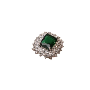 Adjustable emerald zircon ring with double halo of sparkling crystals on a white background