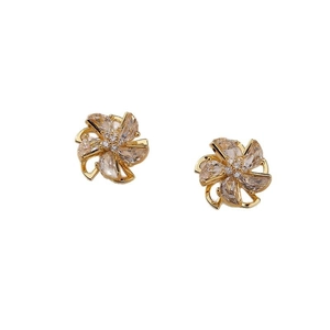 Elegant gold windmill flower earrings with sparkling zircon petals on white background