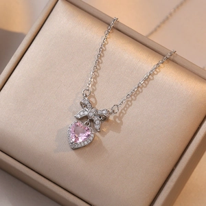 Pink heart pendant necklace with bow accent in a premium satin jewelry box
