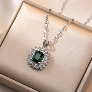 Vintage emerald-cut green zircon necklace with halo diamonds on a silver chain