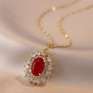 Vintage gold necklace with oval red ruby pendant and sparkling white zircon halo