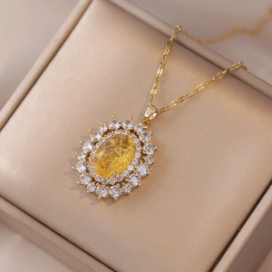 Vintage gold necklace featuring a yellow oval cracked gemstone with double zircon halo