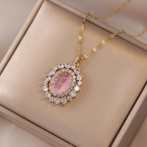 Detail of pink oval gemstone necklace with double-layer diamond halo on jewelry box