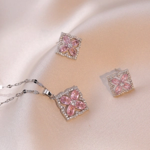 Silver necklace and earrings set featuring pink zircon four-leaf flower pendants