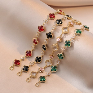 Four-leaf clover bracelets with emerald, red, black, and white stones on gold plating
