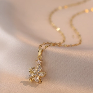 Elegant gold necklace with a rotating star and floral zircon pendant on silk background