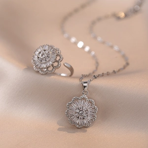 Rotating floral zircon jewelry set with silver necklace and open ring on silk