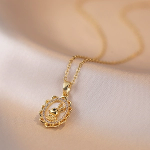 Golden rabbit pendant necklace with zircons and mother of pearl on champagne silk