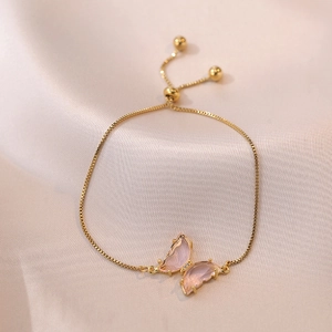 Elegant gold-plated chain bracelet featuring a pink crystal butterfly charm with zircons