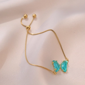 Adjustable gold chain bracelet with sea-blue crystal butterfly charm and sparkling stones