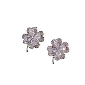 Sparkling silver four-leaf clover stud earrings with heart-shaped zircon stones