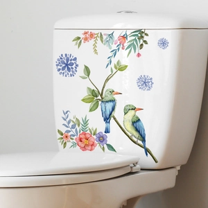 Detail of floral bird wall sticker with pink flowers and kingfishers on a white toilet
