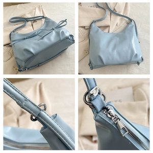 Detail view of light blue pleated hobo bag showing bow tie accents and silver hardware