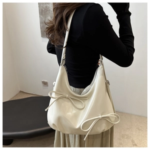 French style cream white bow baguette bag with adjustable strap and glossy finish