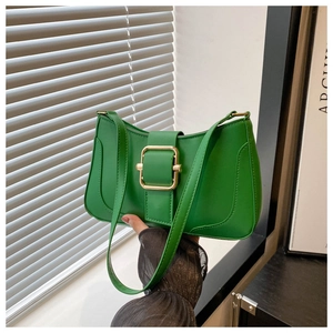 Detail of green leather shoulder bag featuring a square gold metal buckle and sleek stitching