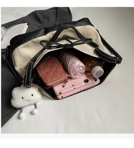 Top view showing large interior capacity of the canvas tote bag with personal items