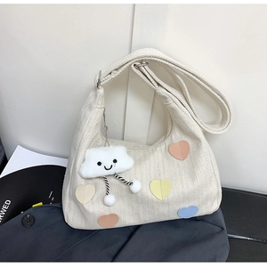 Minimalist canvas tote bag with colorful heart patches and plush cloud charm detail