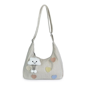 Beige canvas hobo tote with colorful heart patches and a cloud charm, 2024 fashion style