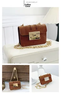 Detail view of brown suede mini crossbody bag with gold chain strap and metal push lock