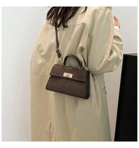 Détail du sac bandoulière en velours marron avec boucle dorée et bandoulière réglable
