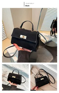 Détail du sac à main noir avec fermoir rotatif doré et texture mate élégante raffinée