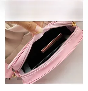 Internal display of the pink floral crossbody bag with zipper and black lining detail