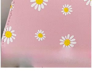 Detailed view of pink floral handbag featuring delicate daisy print and textured surface
