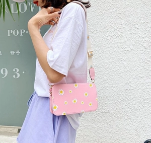 Pink floral square crossbody bag with daisy print and wide adjustable shoulder strap