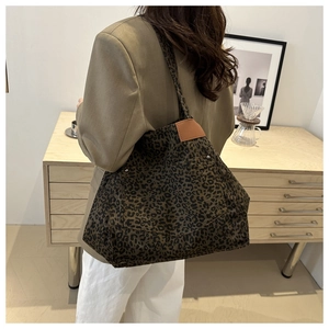 Detailed back view of a leopard print tote bag styled in a cozy home interior setting